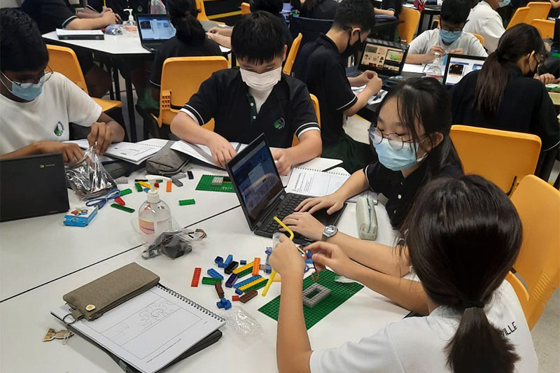 Students coding in class